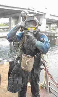 Diver out of the water under a bridge
