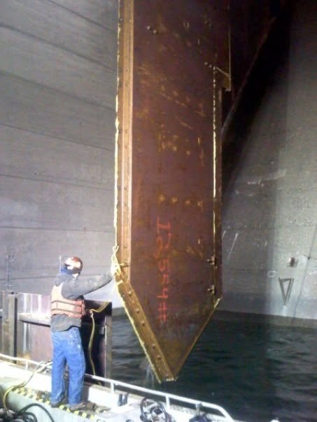 Steel gate panel lowered into place